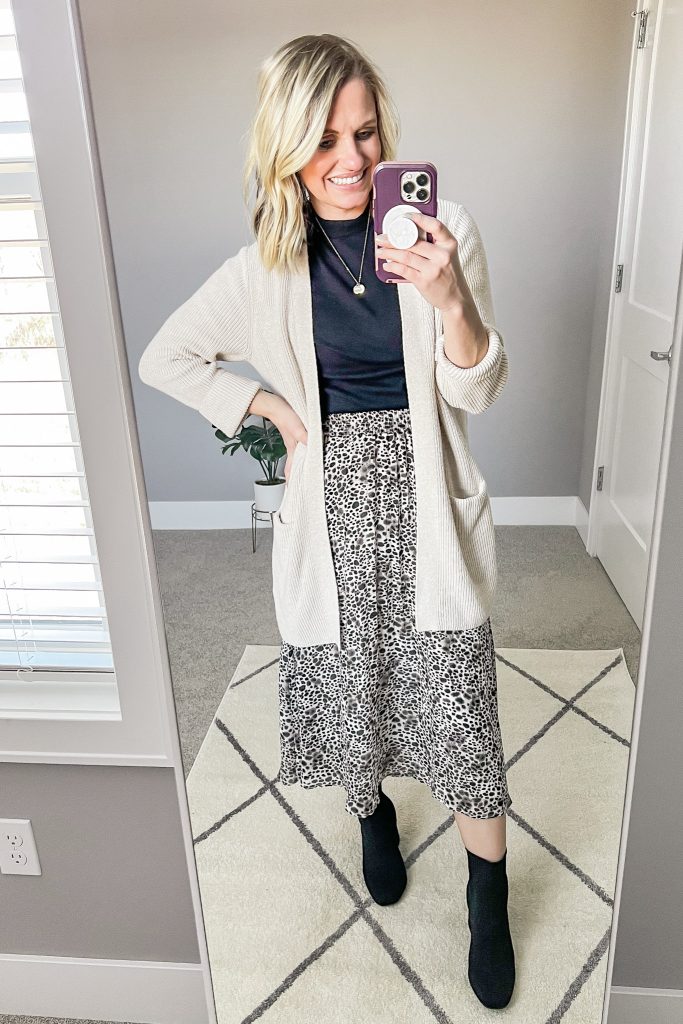 Leopard pleated skirt with turtleneck and cardigan.