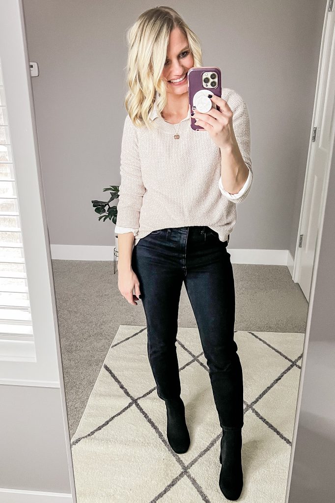 Tan sweater layered over white button down shirt.
