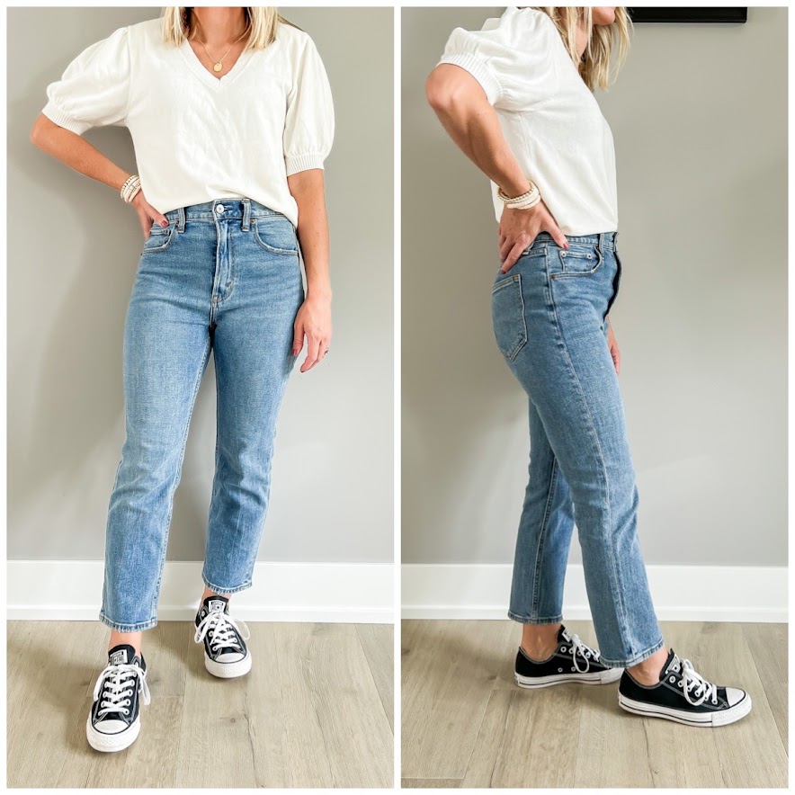 Black converse sneakers paired with straight-leg jeans.