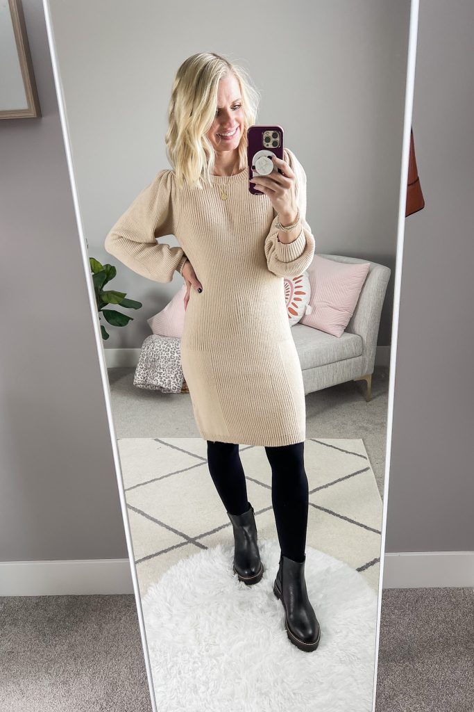 Chelsea boots styled with black opaque tights and a sweater dress.