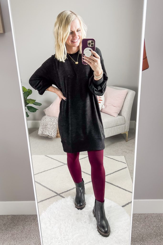 Colored tights with Chelsea boots and a black sweater dress.