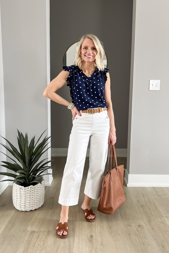 Navy polka-dot blouse with white cropped wide-leg pants. 