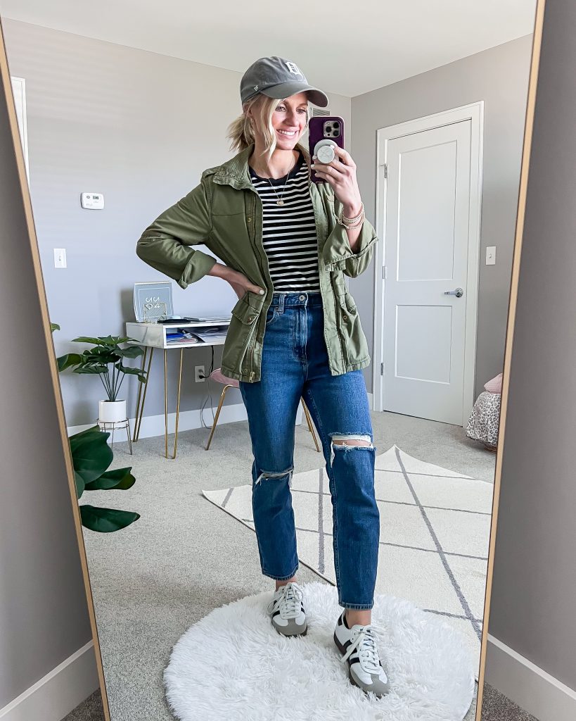 green army jacket and striped tshirt and jeans