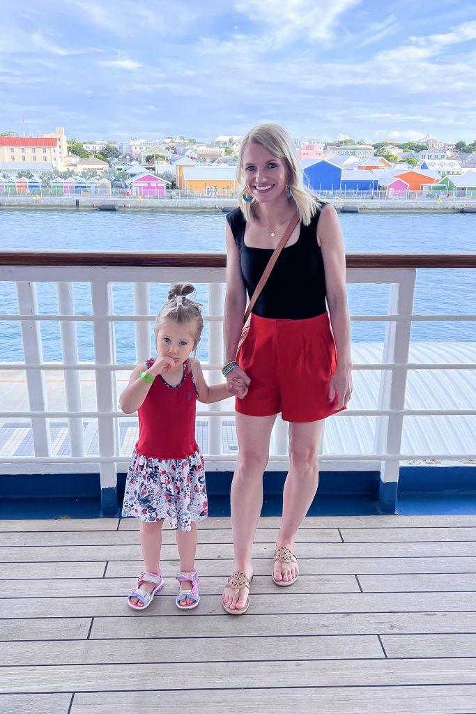 Casual cruise outfit idea with red shorts and a black tank top.