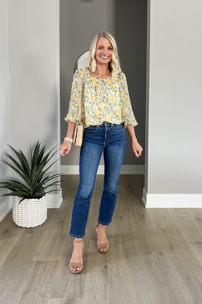 A statement blouse styled with dark jeans.