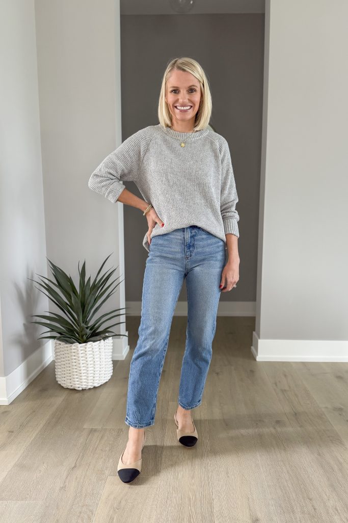 Gray sweater with straight leg jeans.