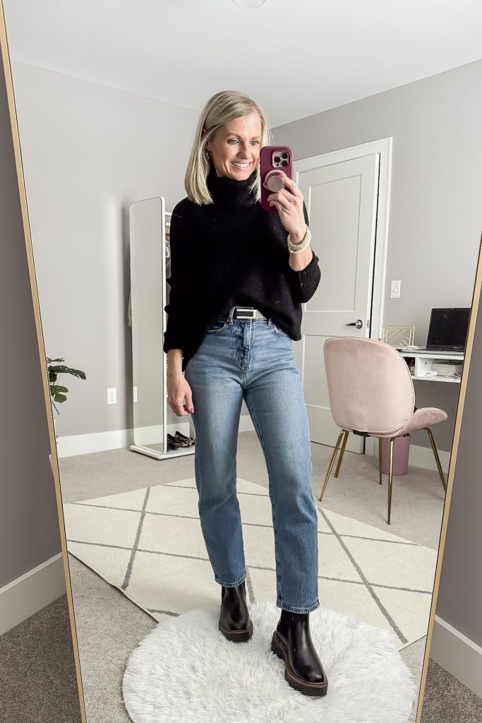 Black turtleneck sweater with straight-leg jeans and black chelsea boots.