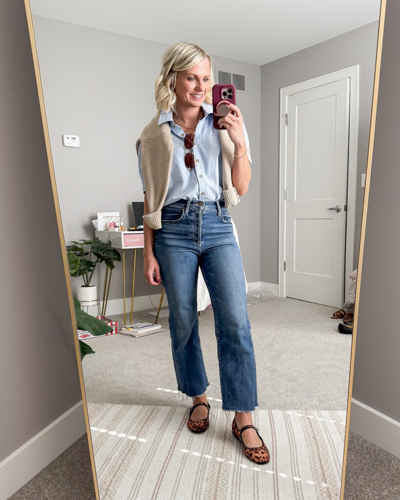 Fall mom outfit idea blue shirt with jeans and a cardigan over the shoulder